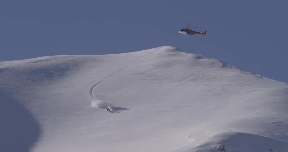 Person snowboarding down a large mountain