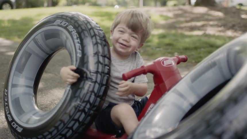 A boy plays with tire floaties