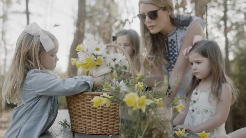 Woman and children arranging flowers in a basket