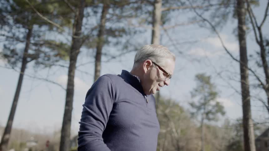 A man stands outside talking