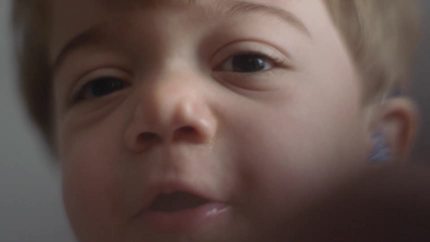 A young boy stares forward