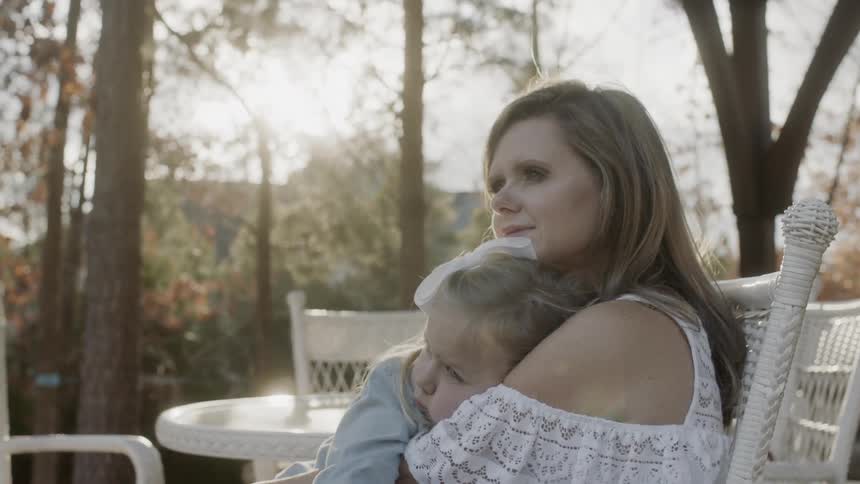 A woman consoles her young daughter