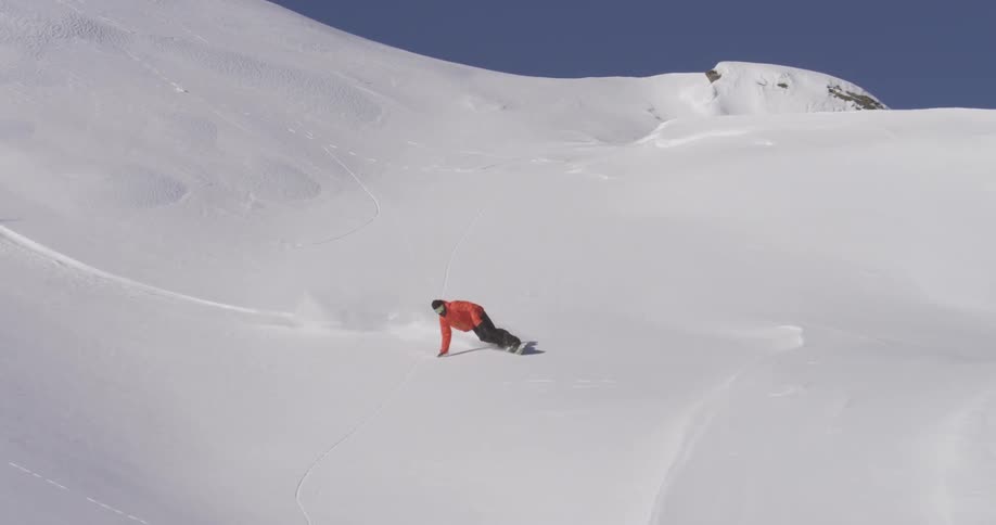 Person snowboarding down a steep slope