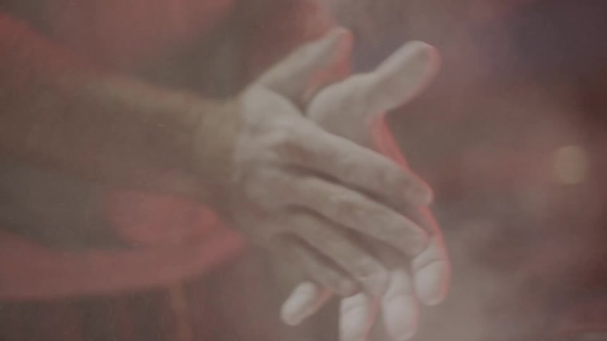 Person with white dusty hands beats them together