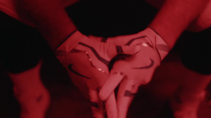 Man adjusts the straps on his white gloves