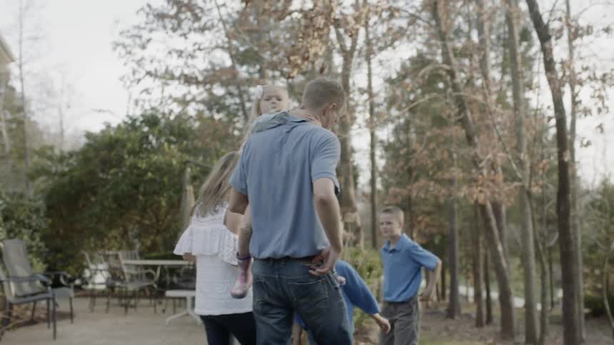 A family walk together in the yard
