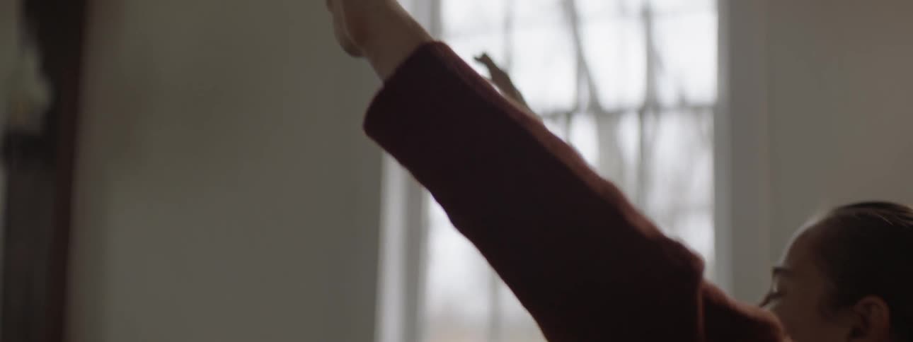 A woman is raising her arms in church