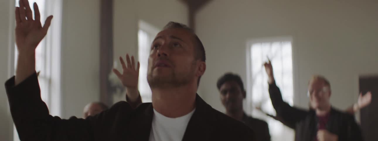 Man holds his hands looking up