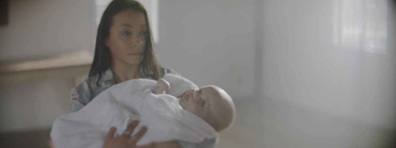 A woman holds a baby in a church