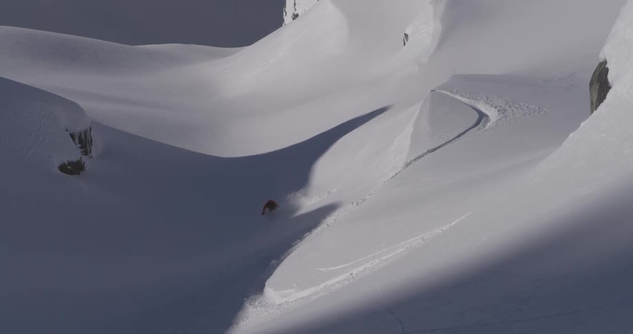 Person snowboarding down a large mountain