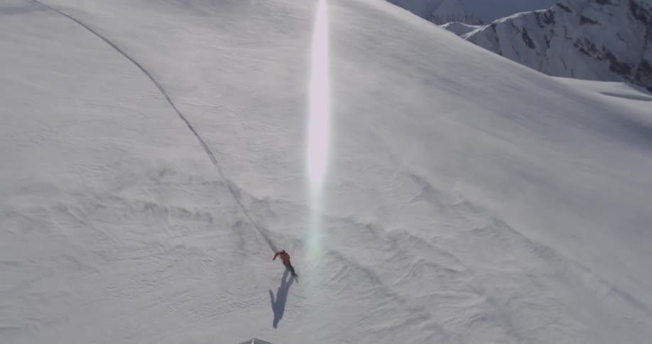 Man snowboarding down a snowy mountain