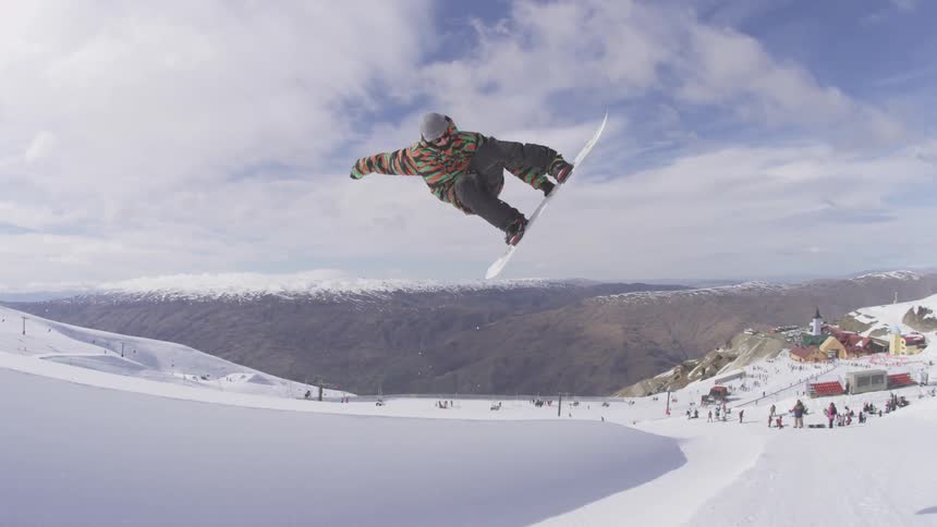 Man doing jumps on his snowboard