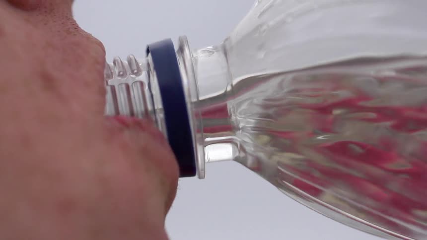 A person drinking water from a bottle