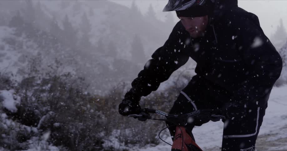 Man Mountain Biking In Snow