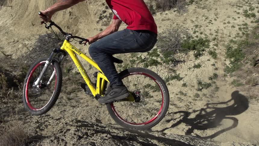 Man riding a bike on a dirt hill