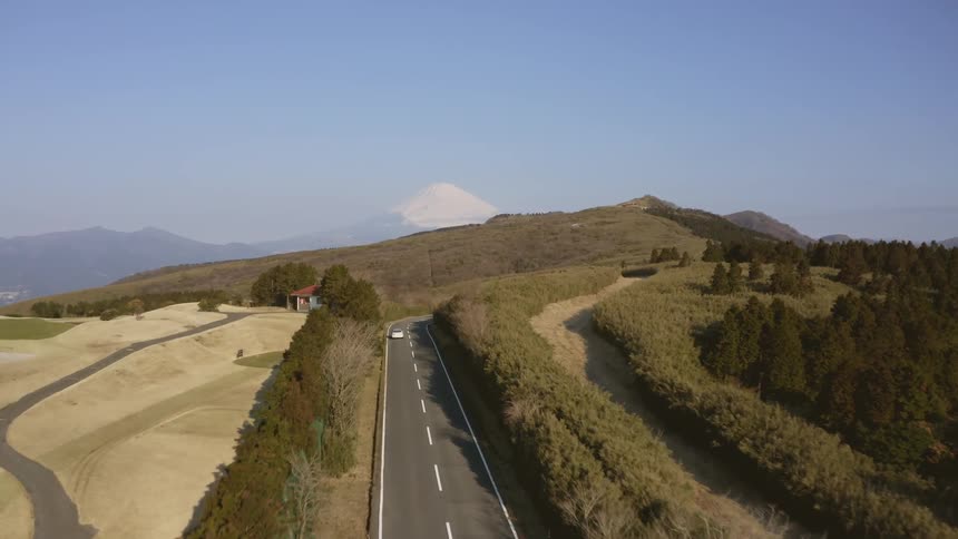 Car drives down a highway through the country