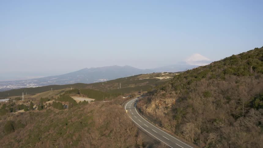 Hilly landscape with a highway going through it