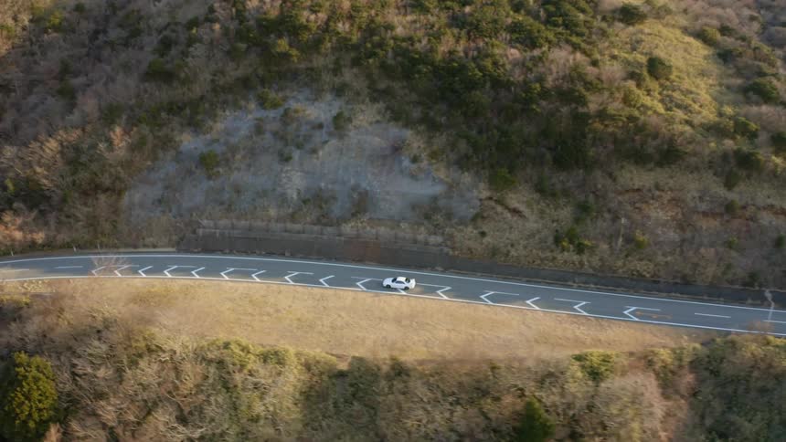 Car drives down a country road