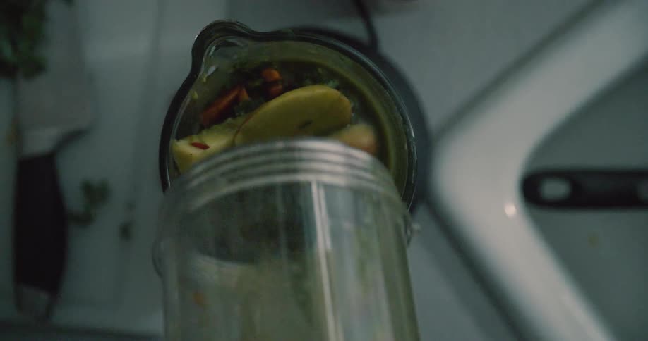 Liquid and food poured into a blender over ice