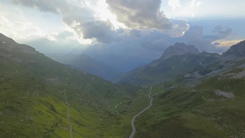 The trail runs through the middle of the green mountain range