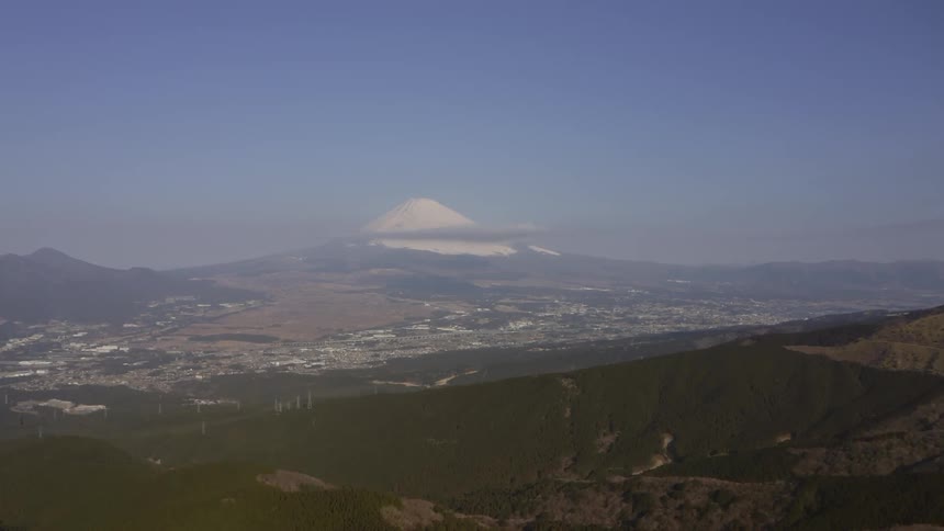 A white mountain peak on the horizon