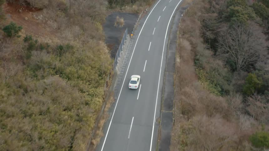 A car travels on a rural road