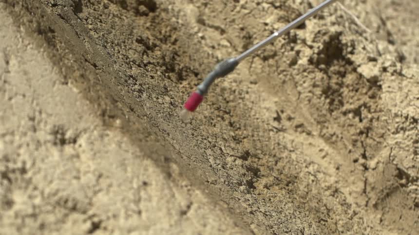 A power sprayer being used on rock