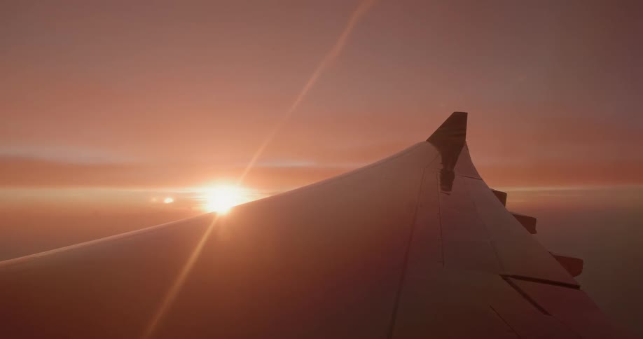 Sun sets behind an airplane wind