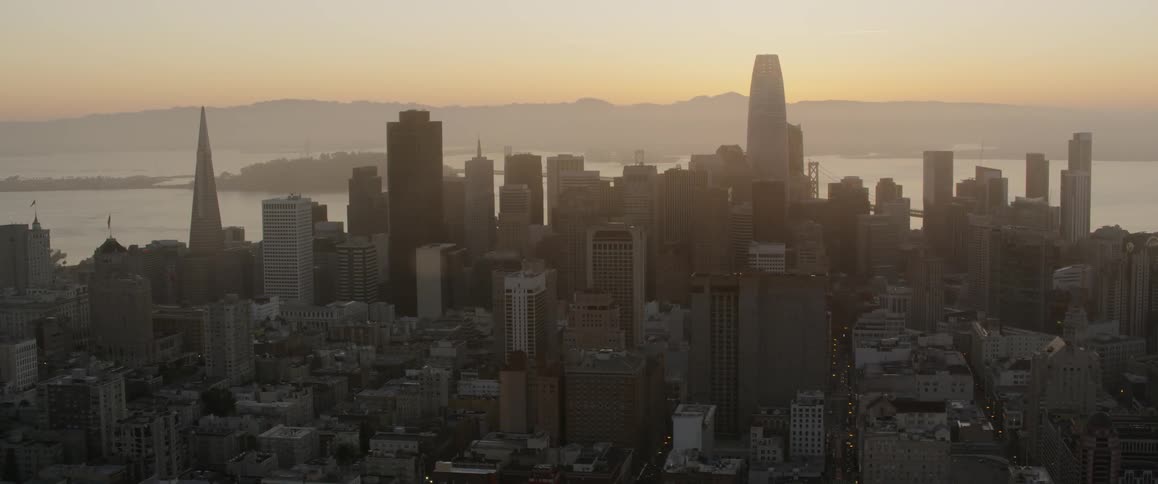 The sun is setting by the coastal city