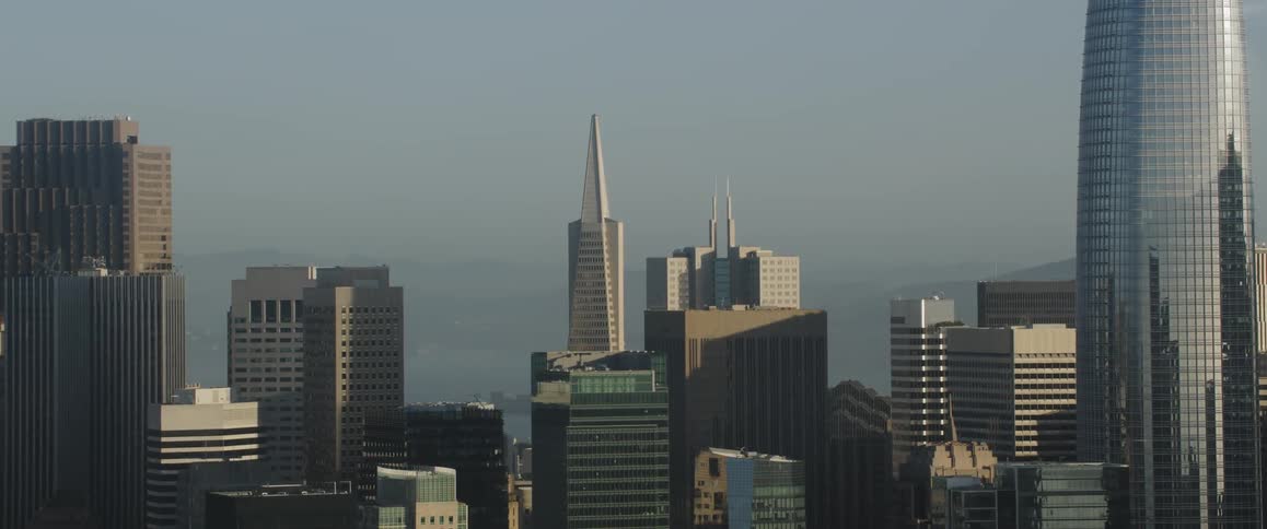 Sun shines down over skyscrapers in a large city