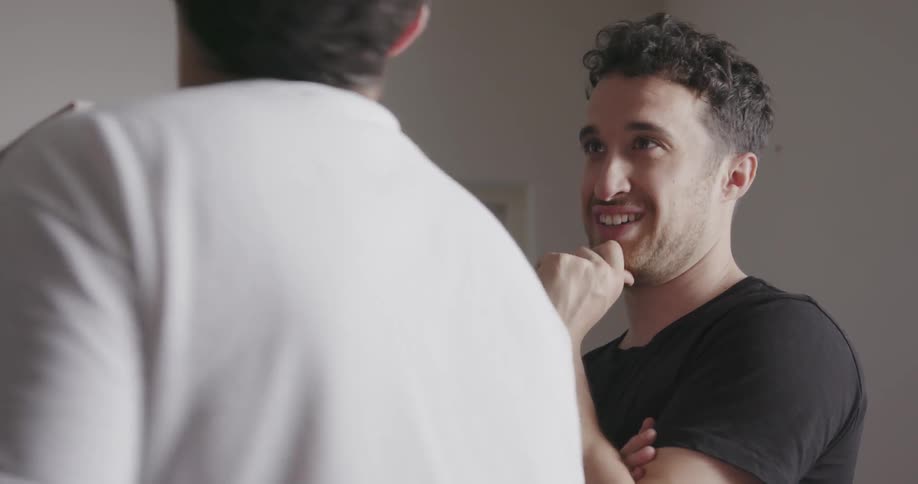 Two men talk and nod their heads