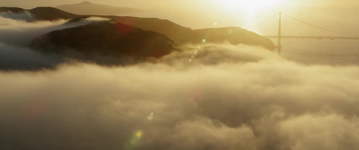 Sun shines over hills and clouds