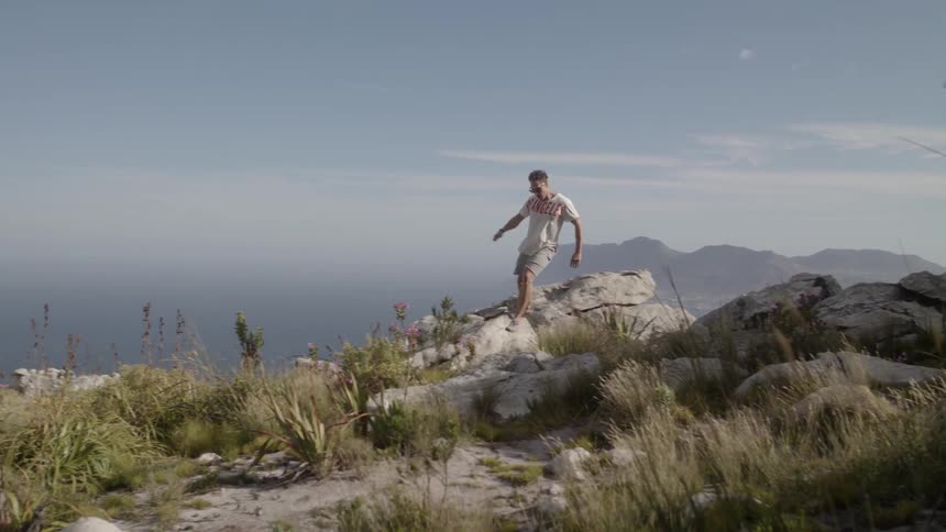 Man runs over the rocks then jumps