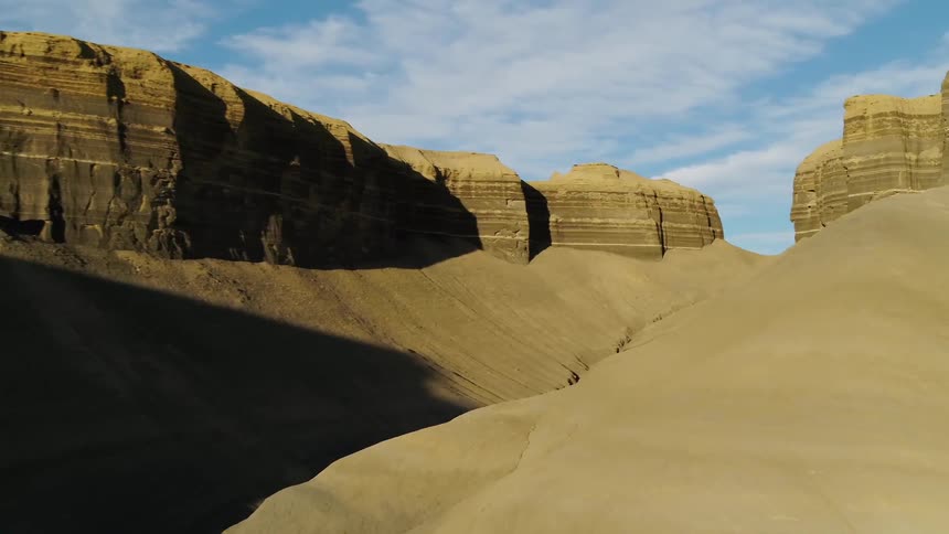Shadows over hilly desert landscape