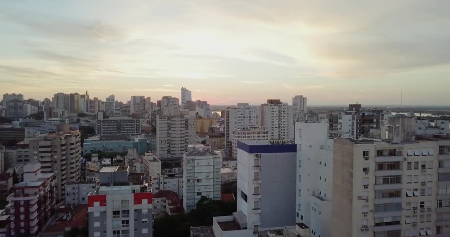 Sun shines through the clouds over a large city