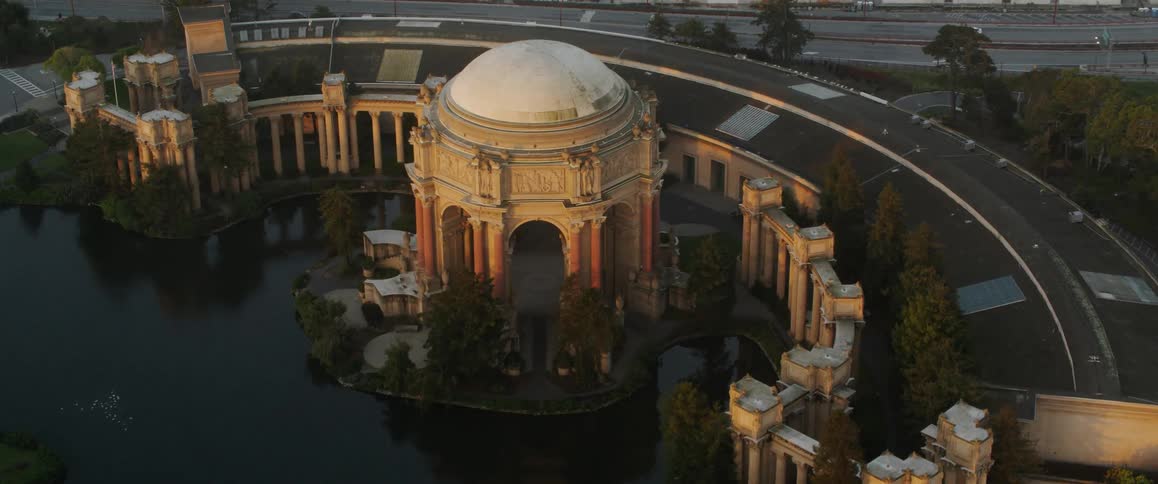 The columns of the palace of fine arts are reflected in the surface of the water