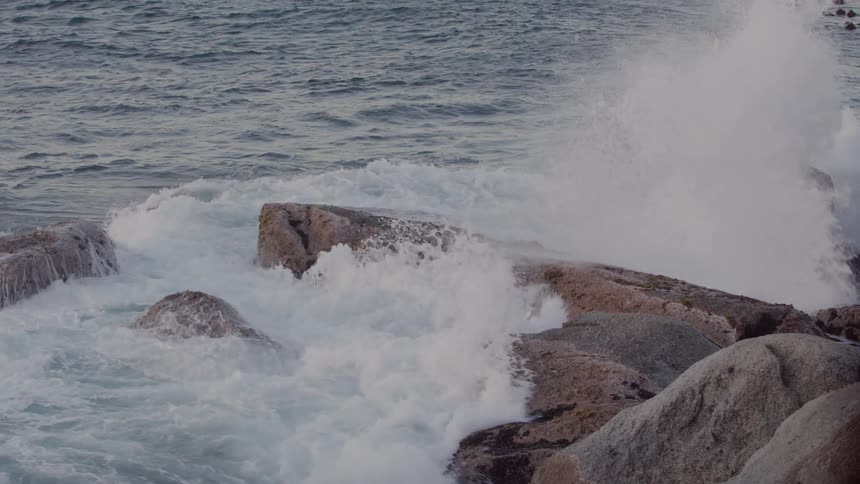 Water splashes up on rocks