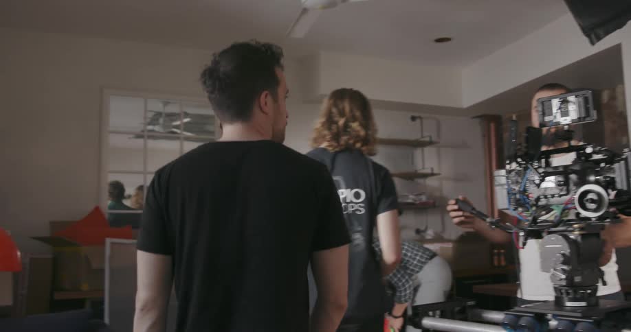 A film crew is working inside a home during the day