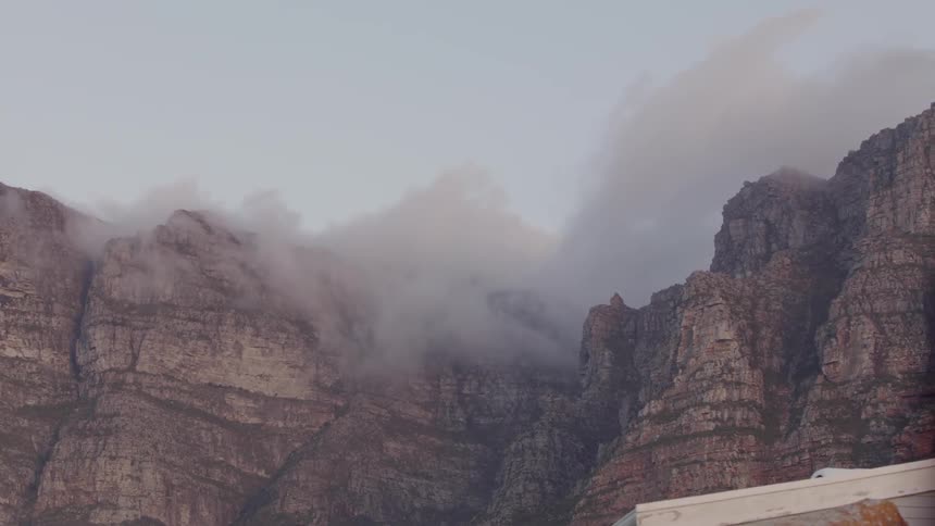 Fog floats over rocky cliffs
