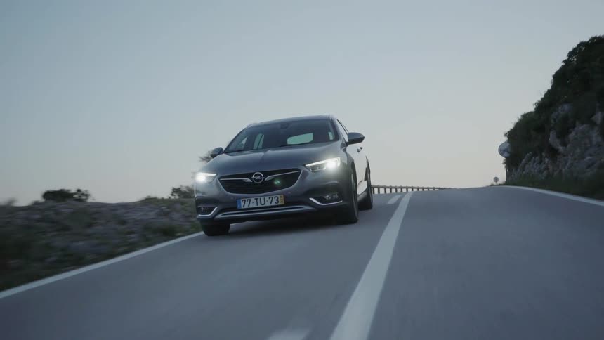 Car drives down a country road in the evening