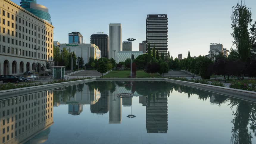 City buildings are reflected on the surface of the reflecting pool