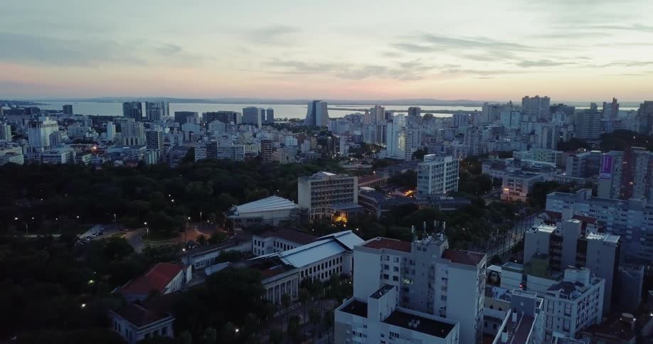 The sun is setting over the coastal city