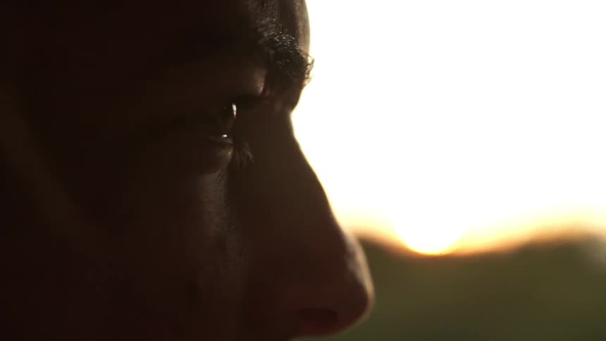 Man travels in a vehicle at sunset