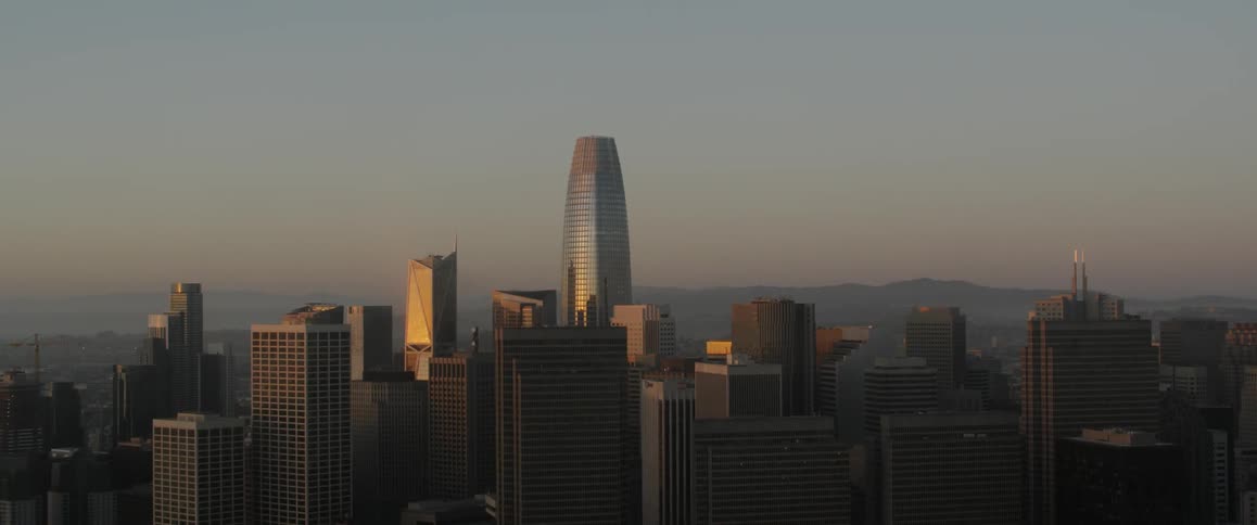 Tall skyscrapers reflecting the setting sun