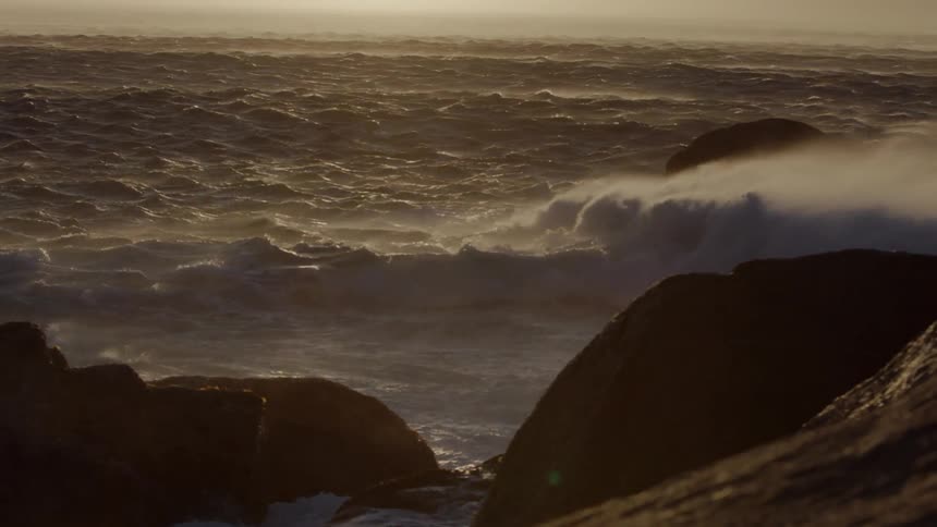 Rough waves crash into the rocks