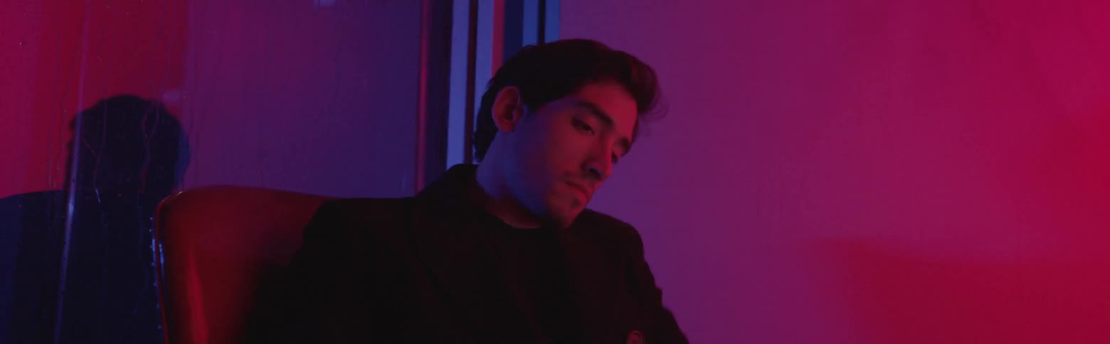 A man is looking around then getting up from a chair and leaving