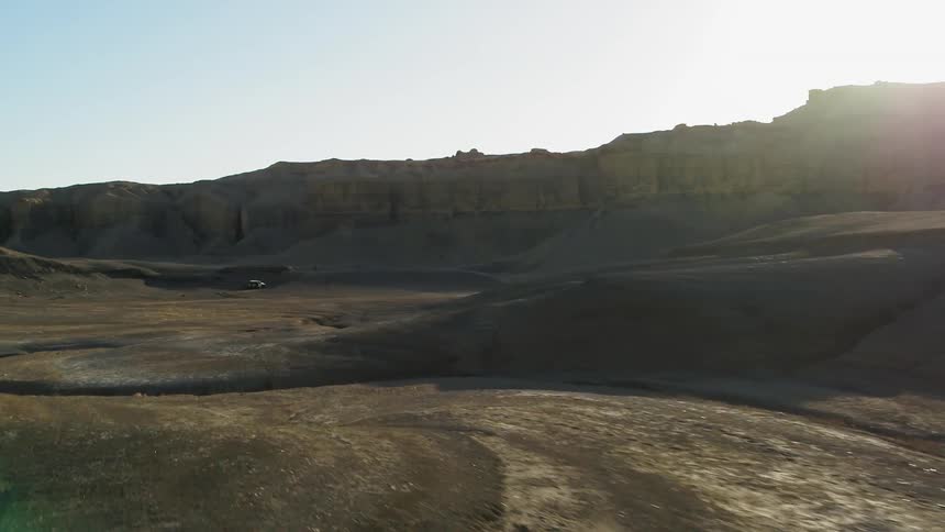 Sun shines over sandy hilly plains