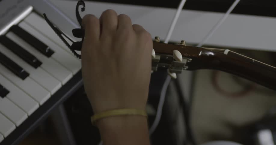 Person is tuning a guitar