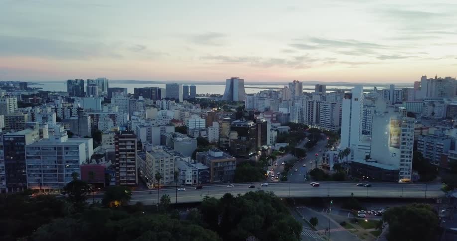 Large city next to a body of water at sunset