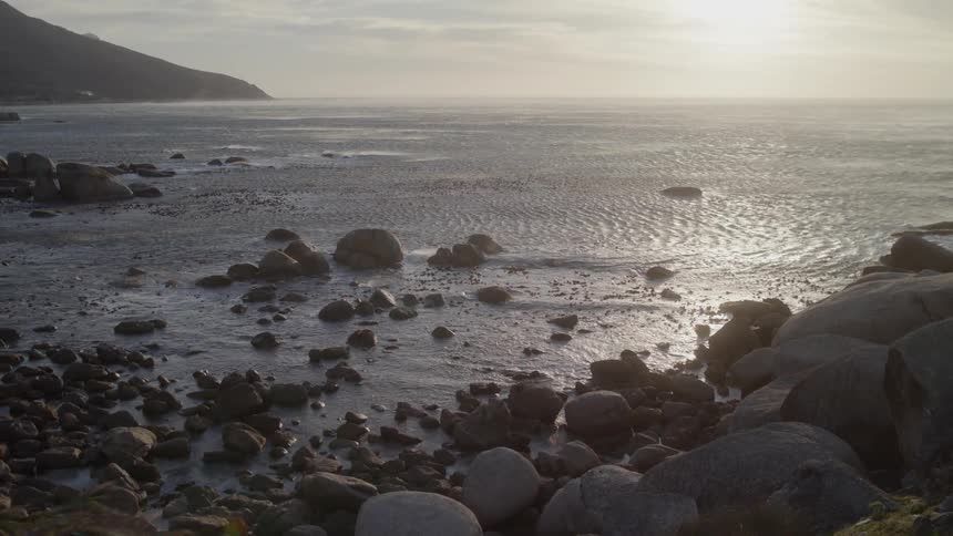 Sun shines over rocky beach